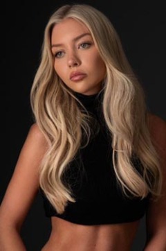 Talia thumbnail - in a black high-neck crop top on a dark backdrop